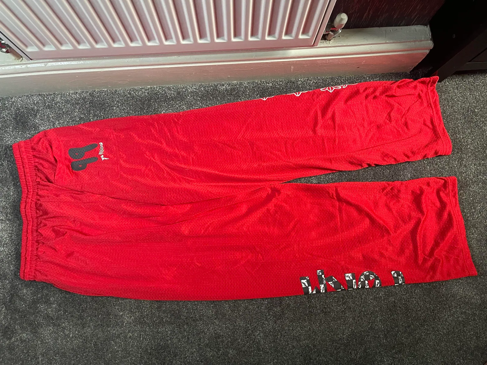 Red mesh trousers with black and white leg graphics