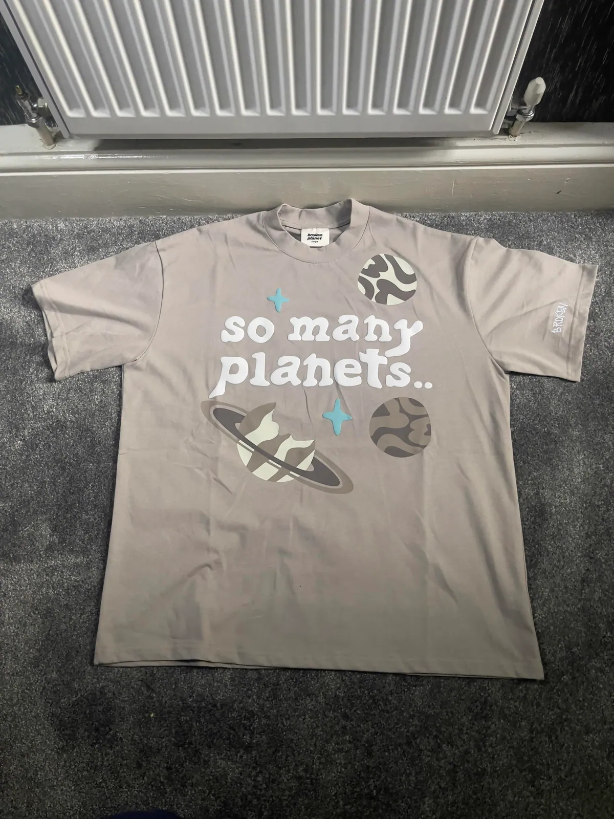 Gray graphic T-shirt with text across the chest