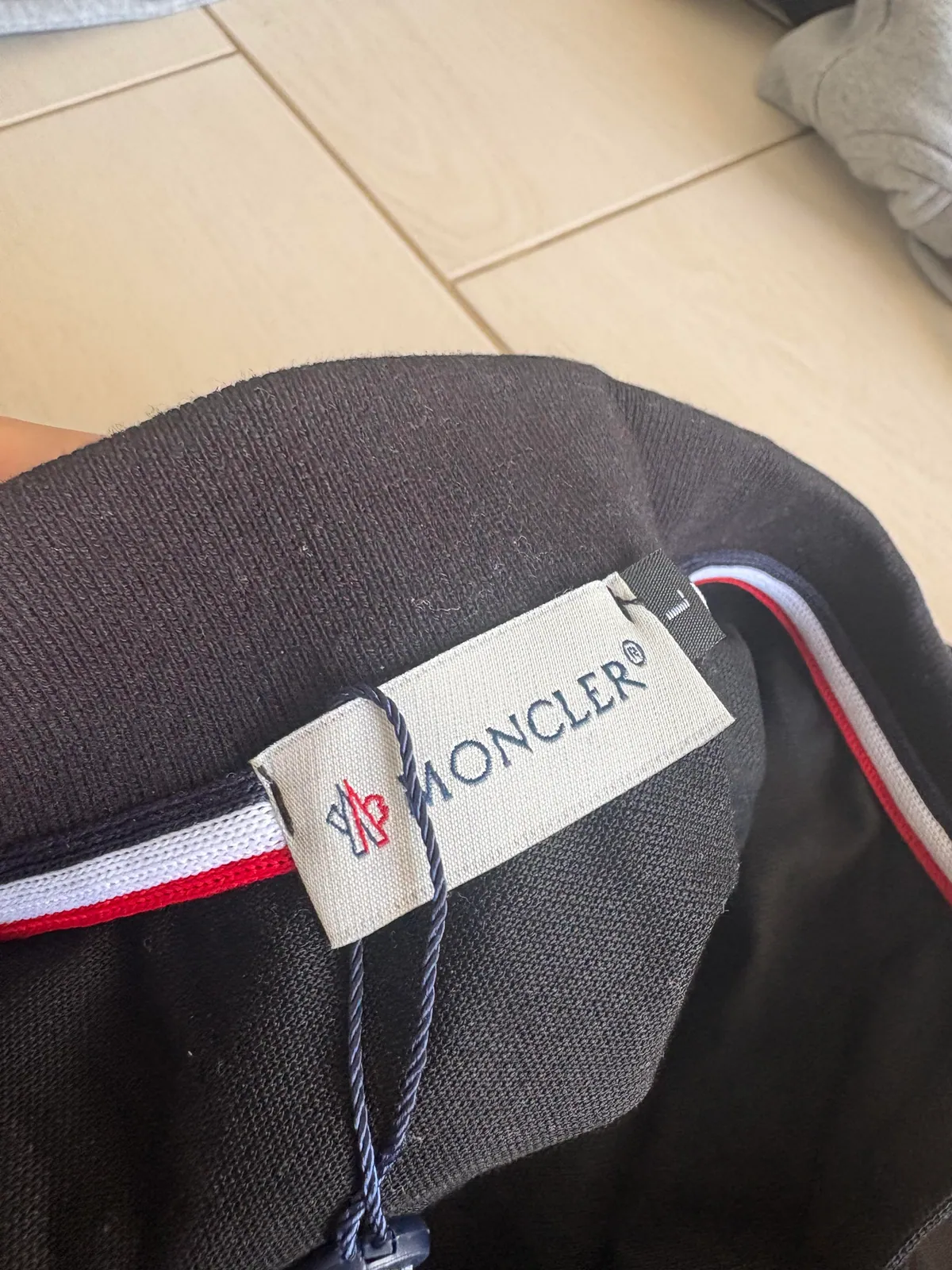 Woven neck label inside the black polo shirt