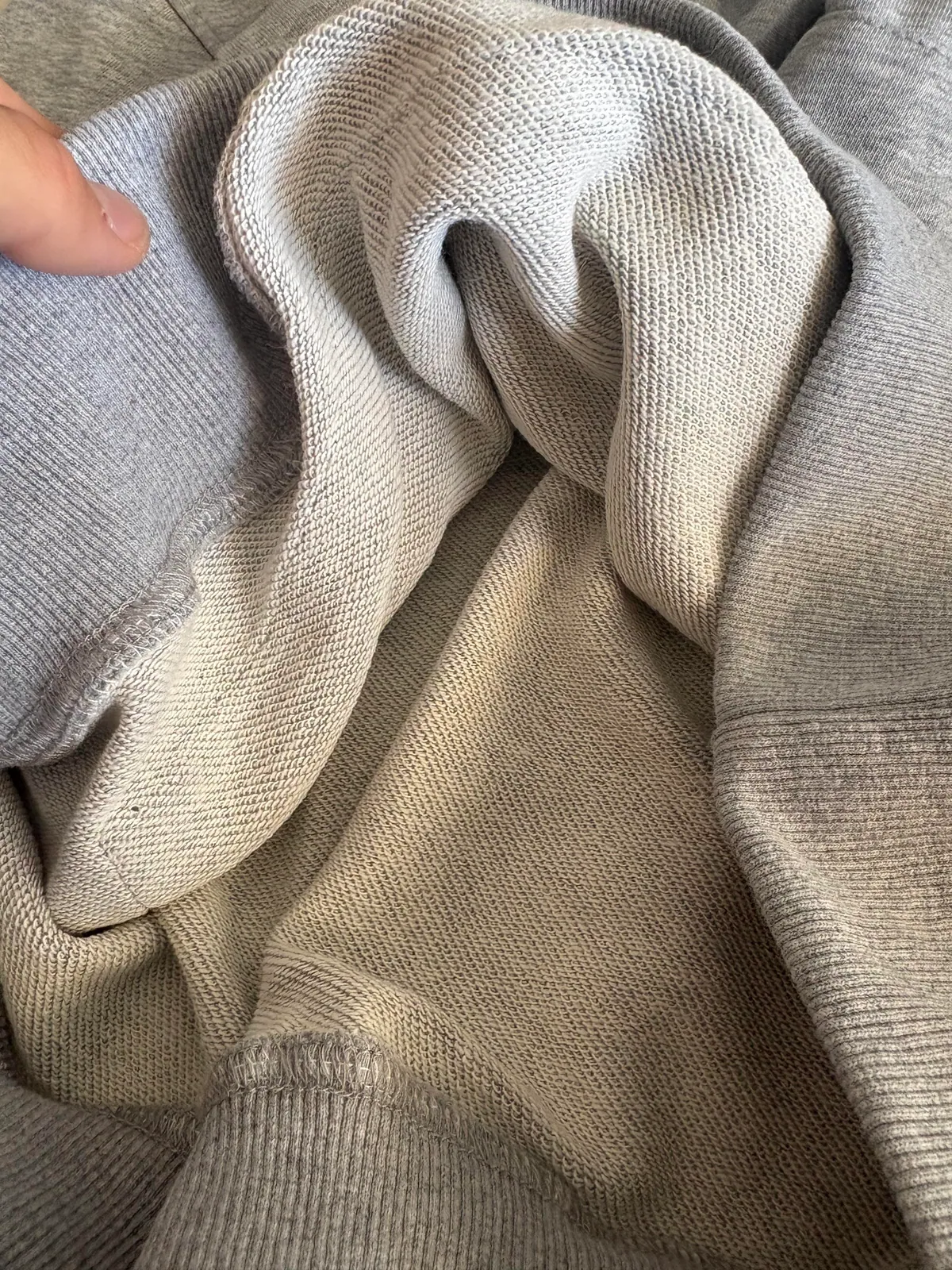 Looped inner fabric of a gray hooded garment