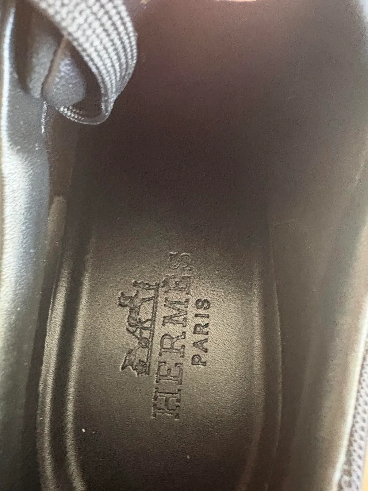 Printed lettering on the insole of a black shoe