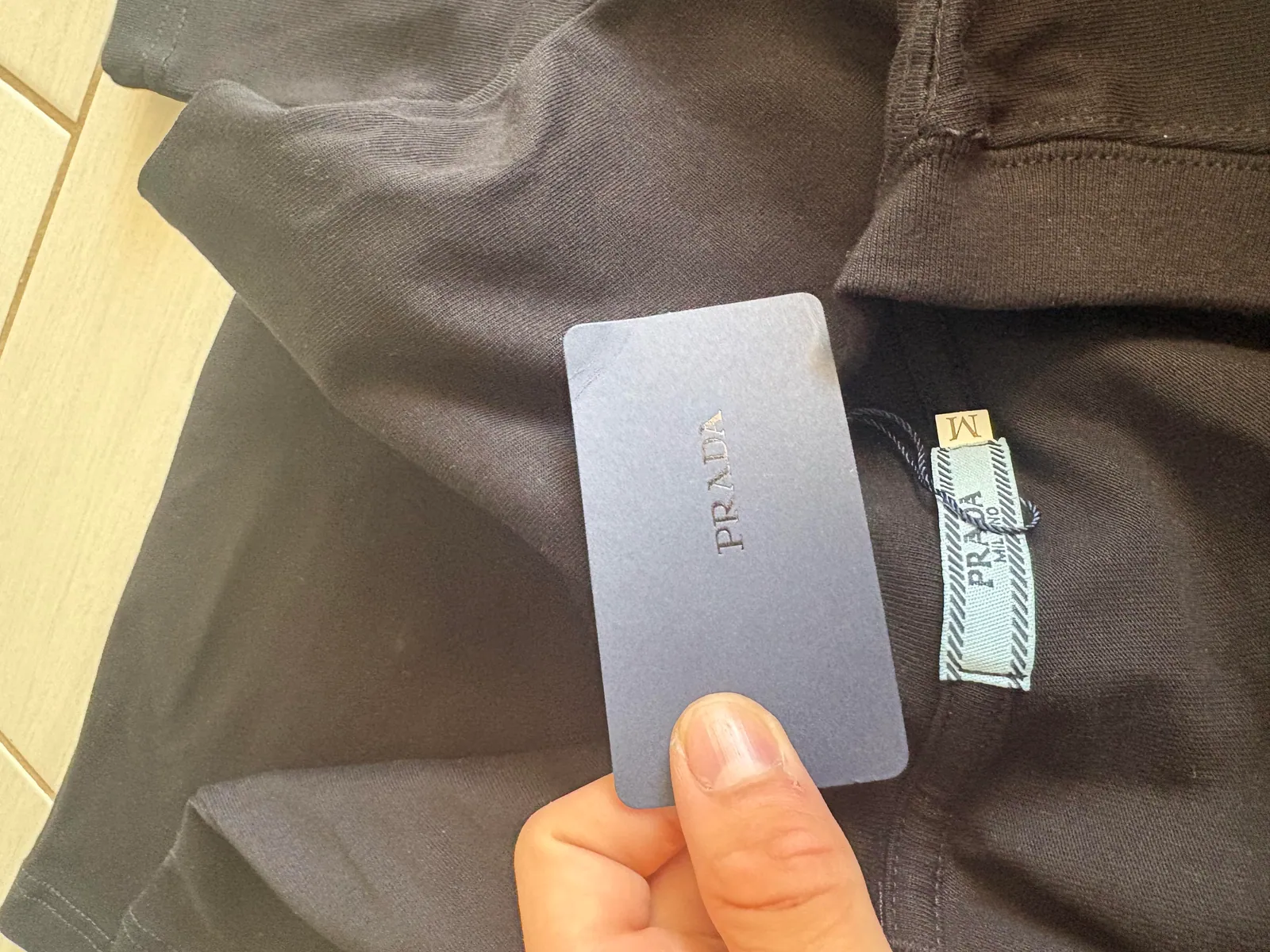 Woven neck label and hanging tag inside the black T-shirt