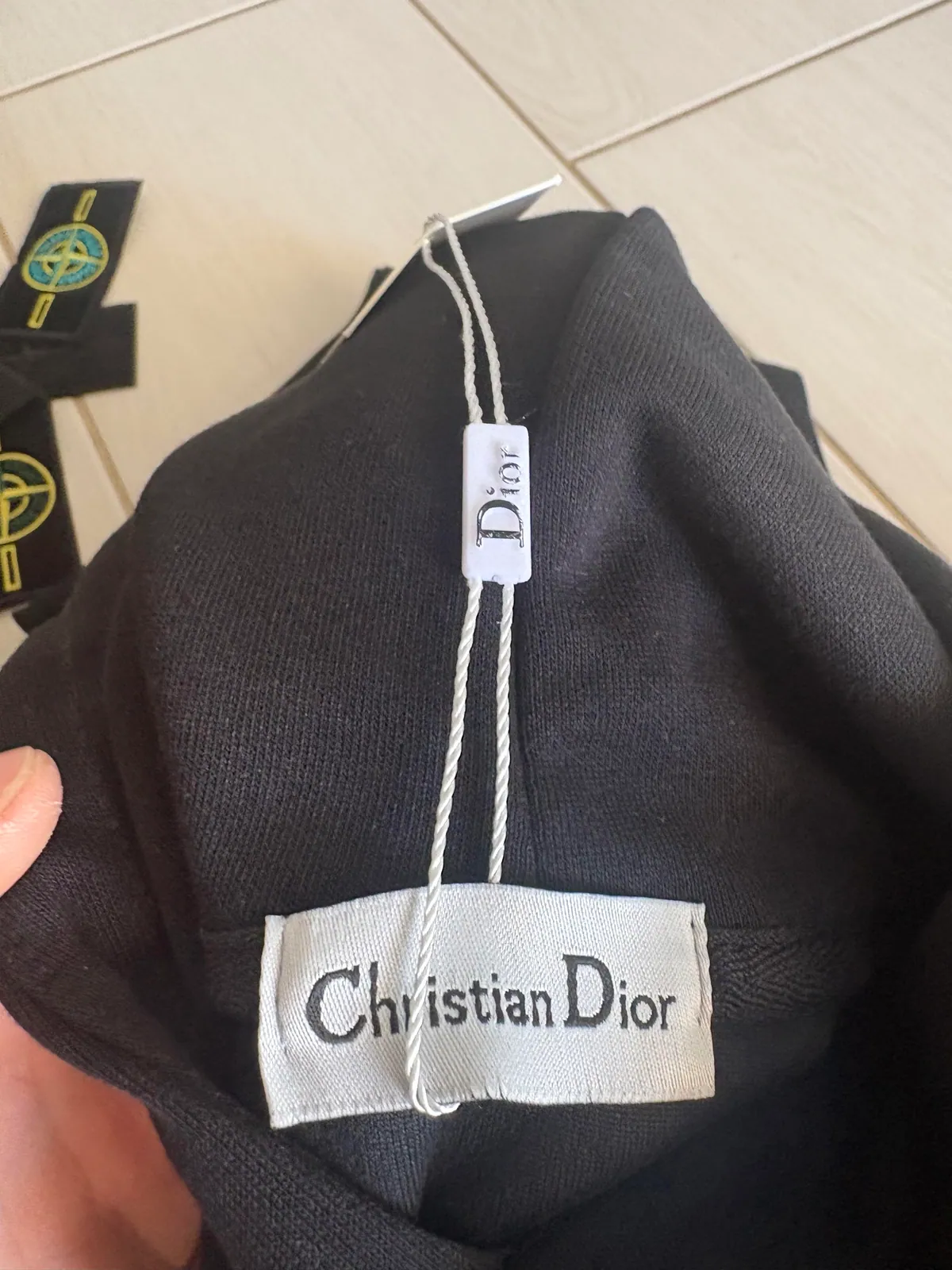 Woven label and hanging tag inside a black garment