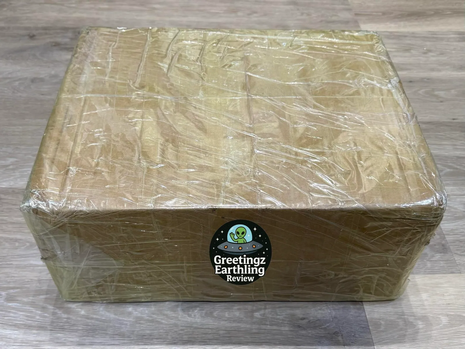 Large taped cardboard parcel on a wood floor