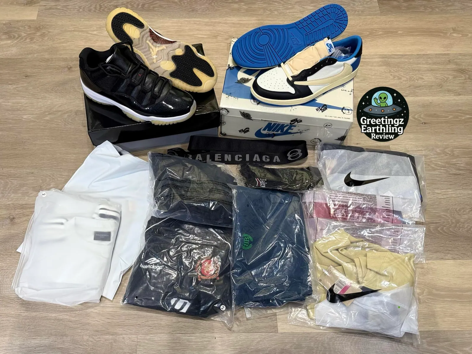 Two sneaker pairs and several bagged garments arranged together