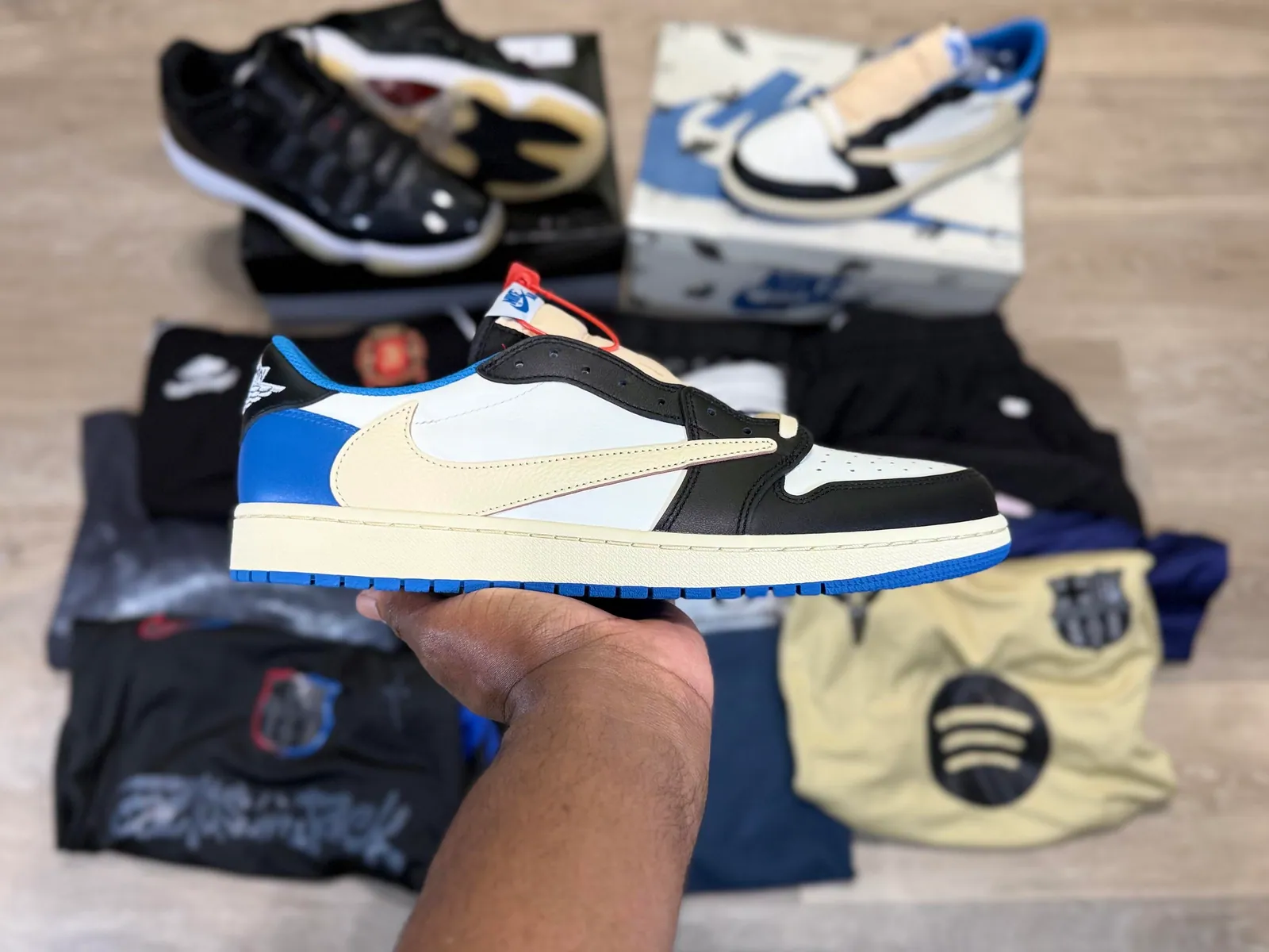 Blue, black and white low-top sneaker held in front of the haul