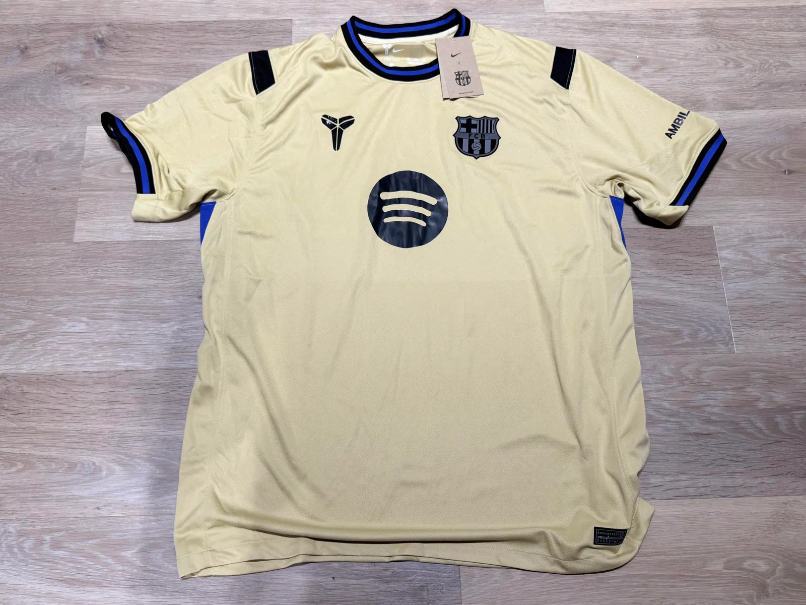 Cream football jersey with dark trim laid flat