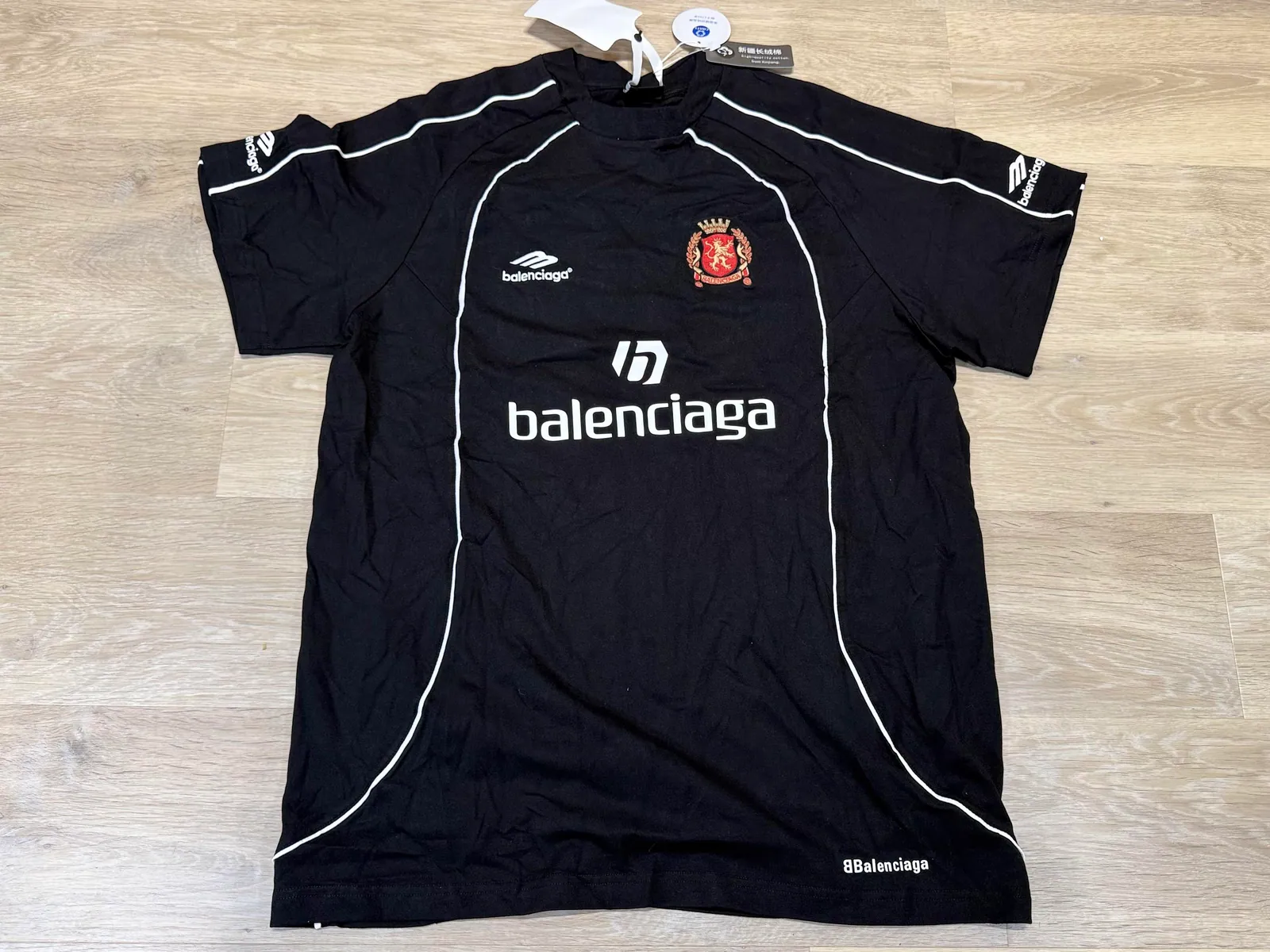Front of a black football shirt with white piping