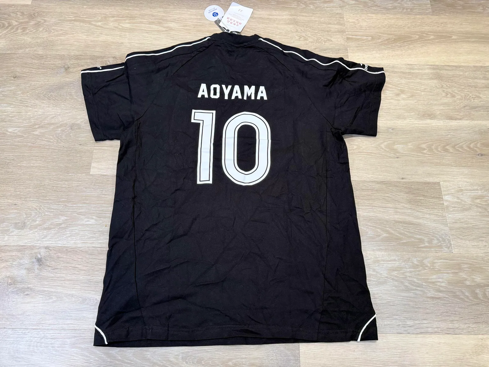 Back of a black football shirt printed AOYAMA 10