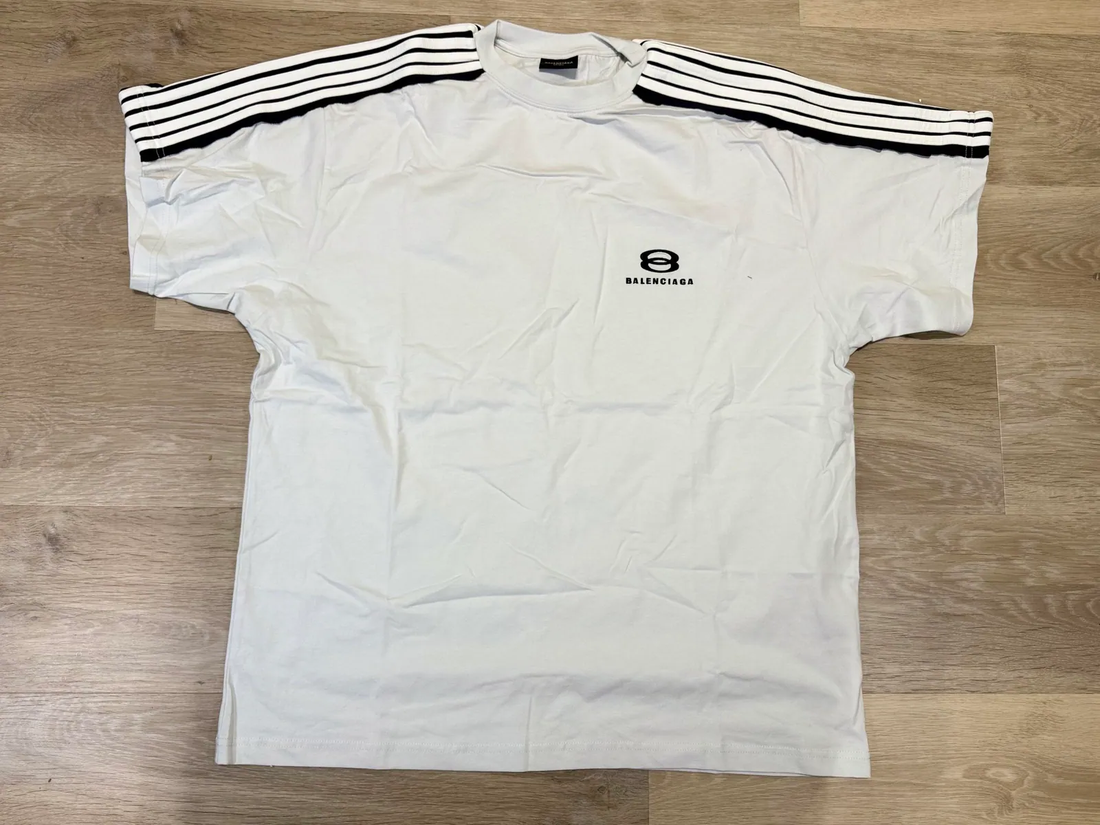 White short-sleeve shirt with black shoulder stripes