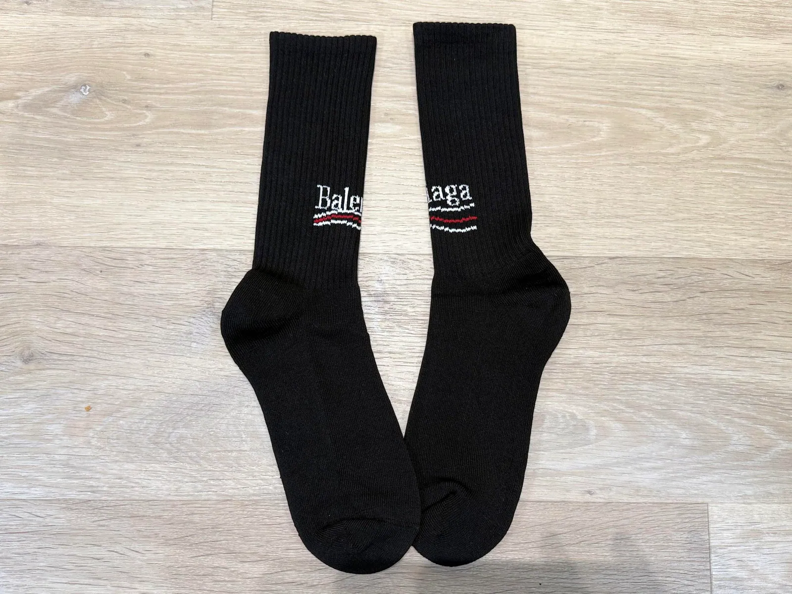 Pair of black crew socks laid flat