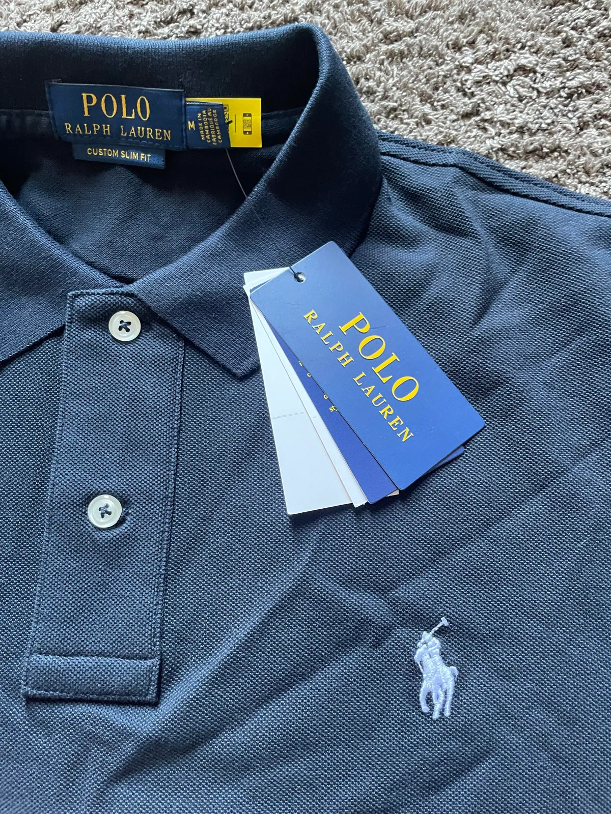 Close-up of the navy polo collar and tags