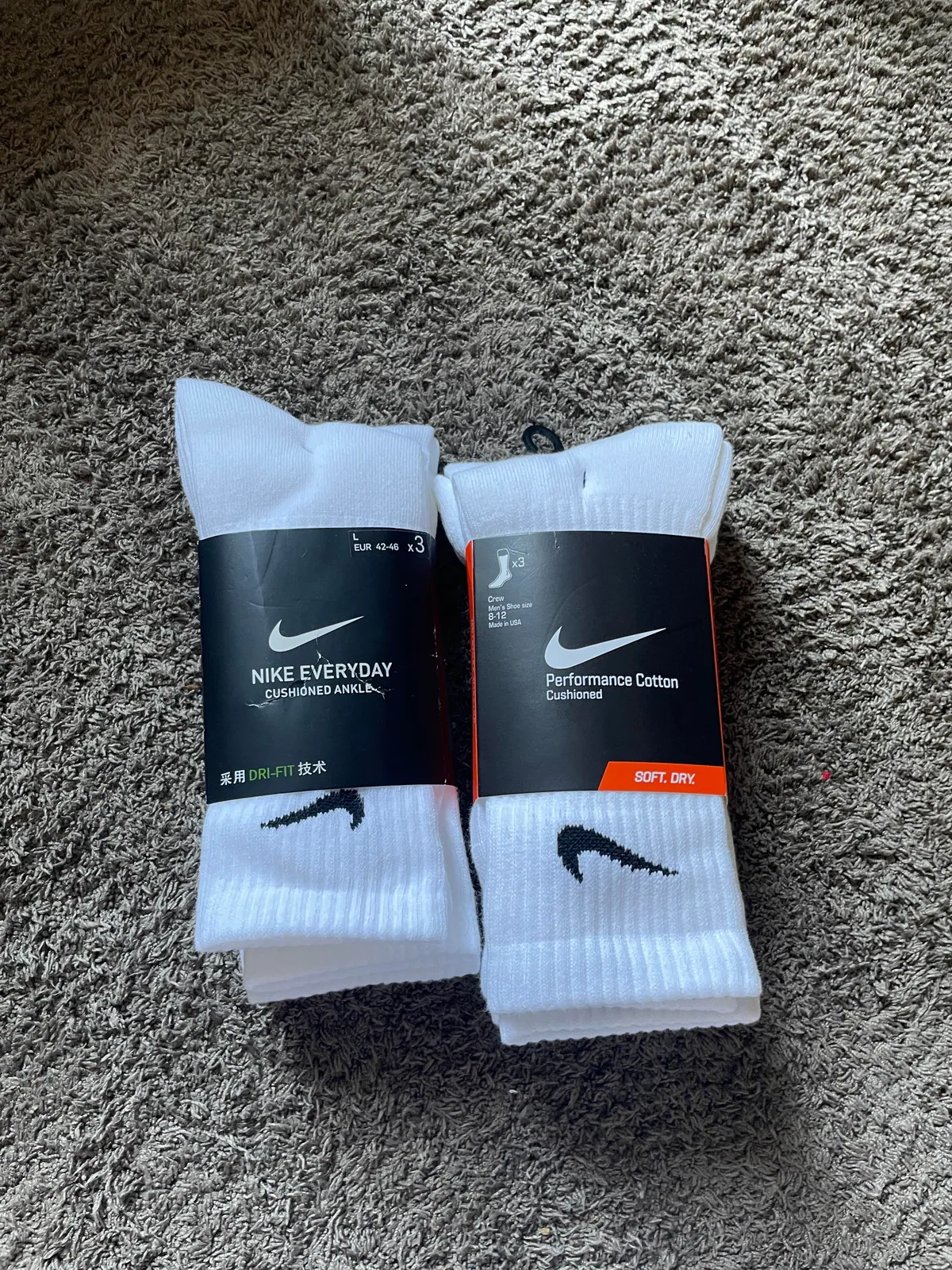 Two wrapped packs of white athletic socks