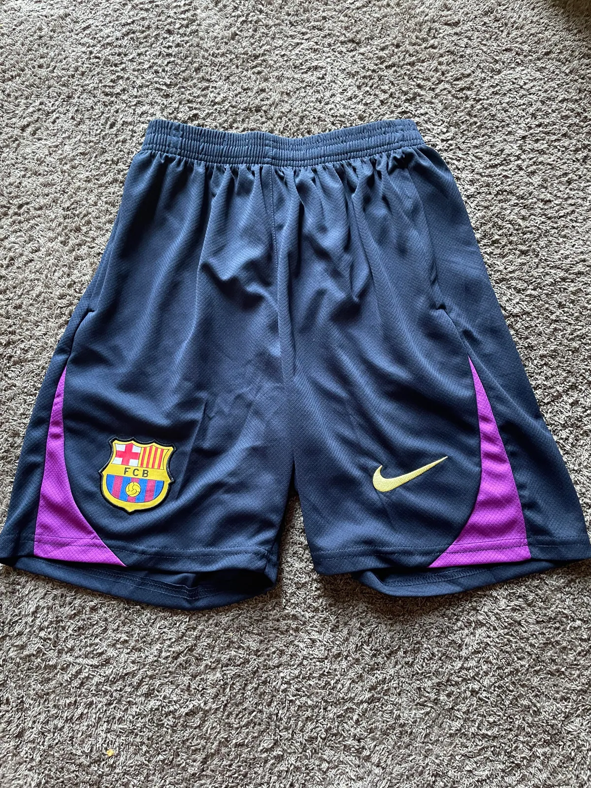 Matching dark football shorts with purple side panels