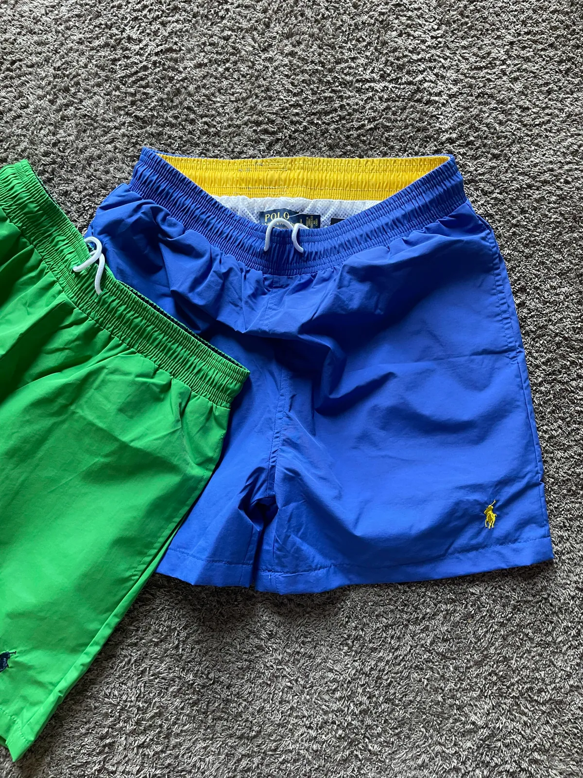 Blue and green shorts laid next to each other